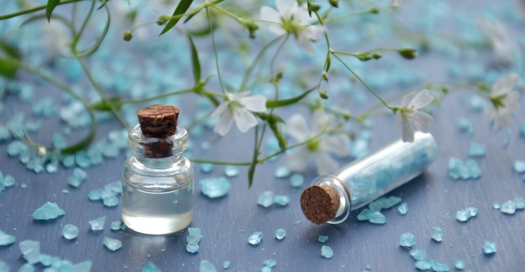 Two Clear Glass Bottles With Corks