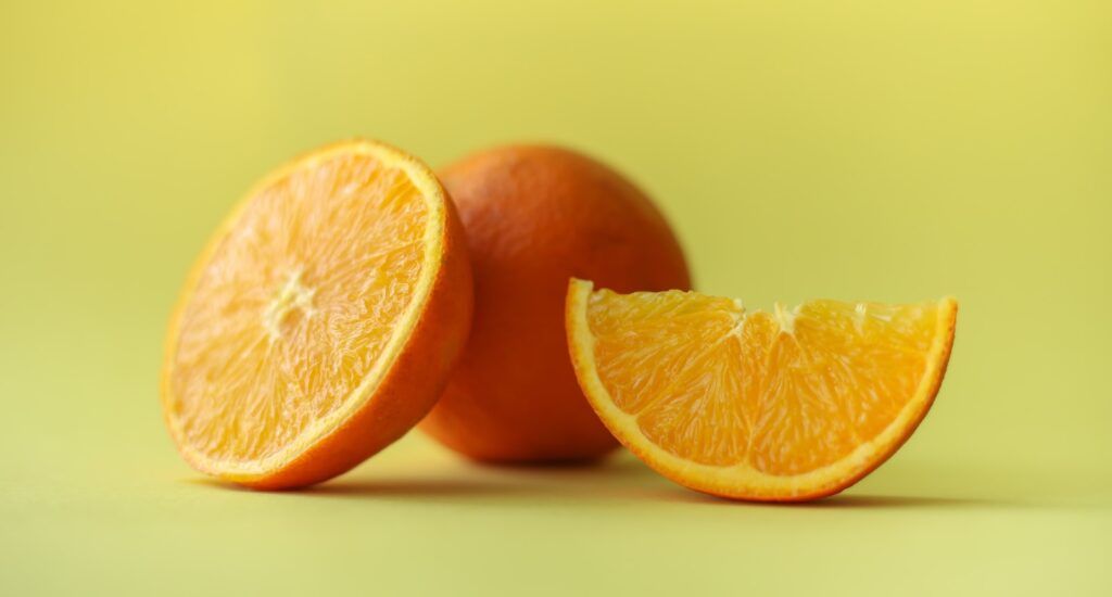 sliced orange fruit on white table