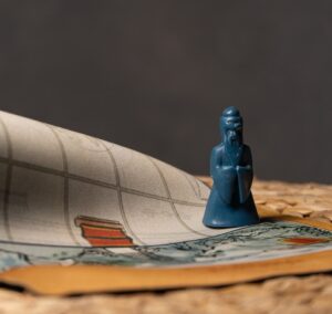 a small blue figurine sitting on top of a rug