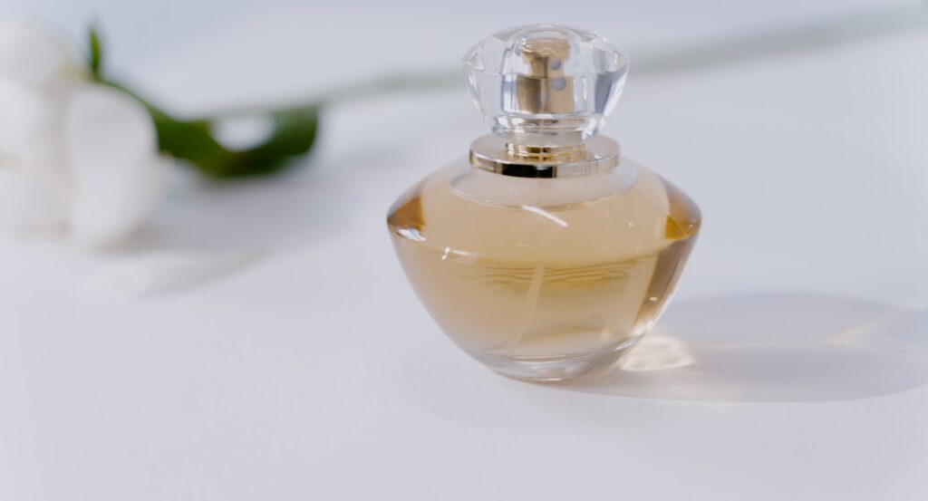 A Clear Glass Perfume Bottle on the Table