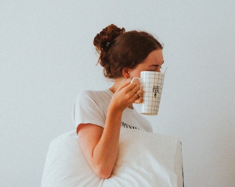 woman in white t-shirt reading book