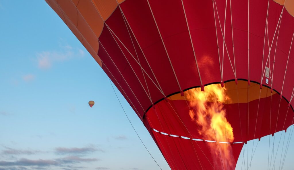 red hot air balloon during daytime