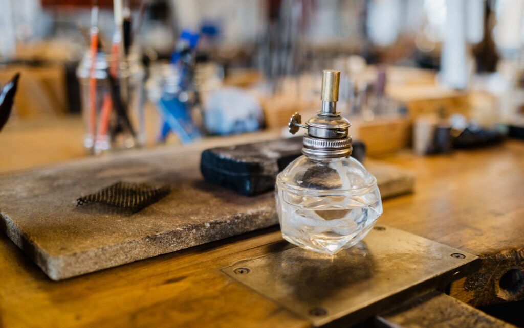 clear glass perfume bottle on brown wooden table