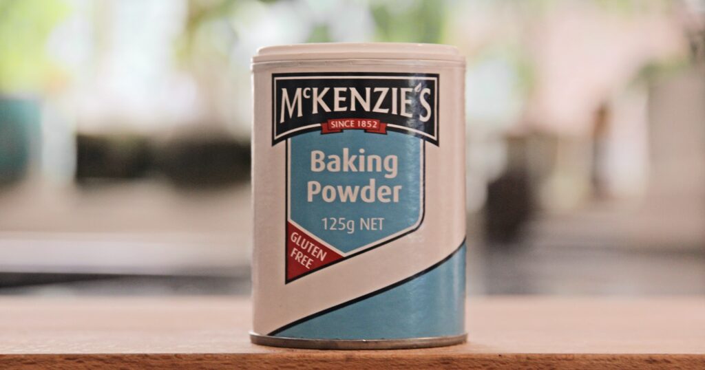 a can of baking powder sitting on a table