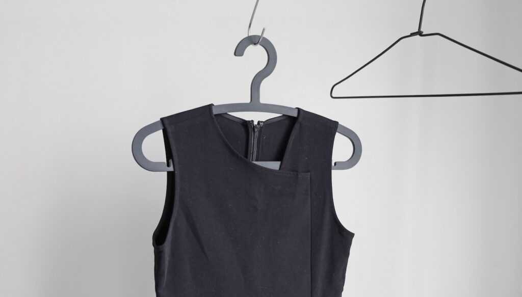 black sleeveless top hanging on wardrobe