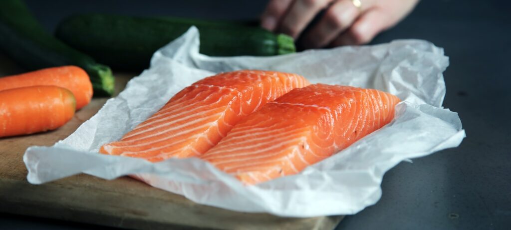 raw fish meat on brown chopping board