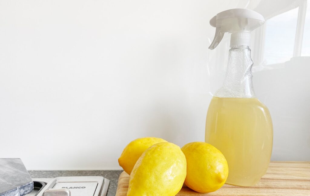 yellow lemon fruit beside clear glass bottle