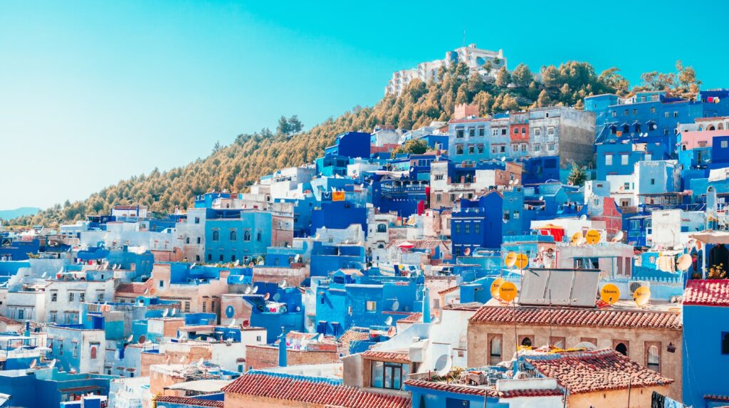 blue and white painted houses on the cliff