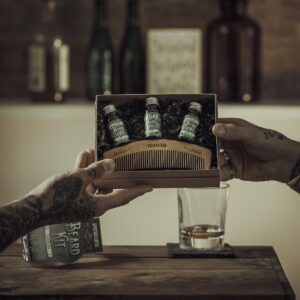 person holding green glass bottle