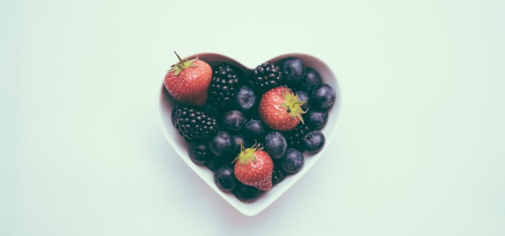 heart-shaped bowl with strawberries