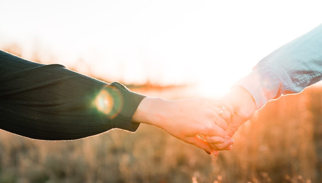 two person holding each other's hands