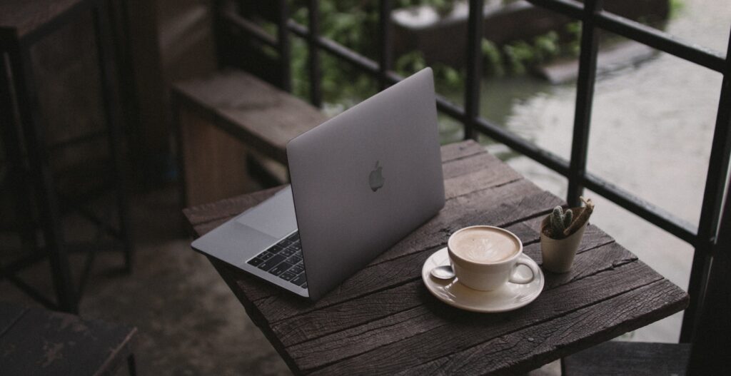 macbook air on brown wooden table