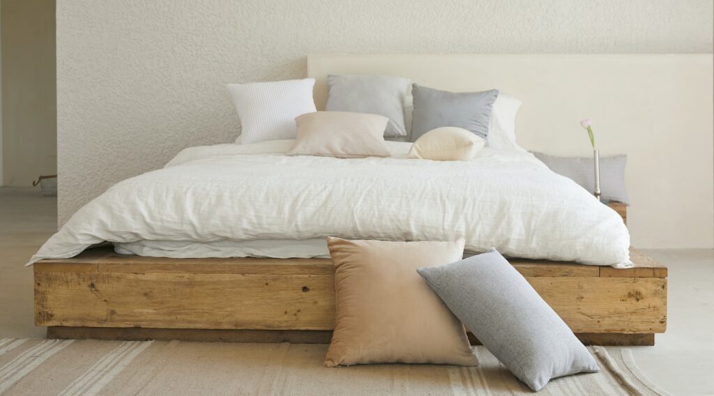 white bed pillow on brown wooden bed frame