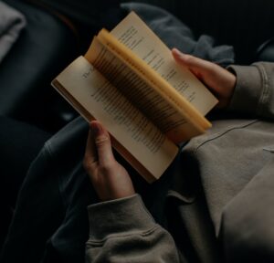 person reading book white sitting