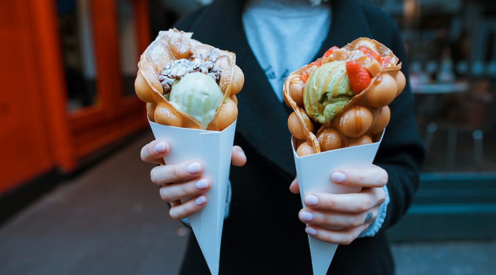 person holding two ice creams