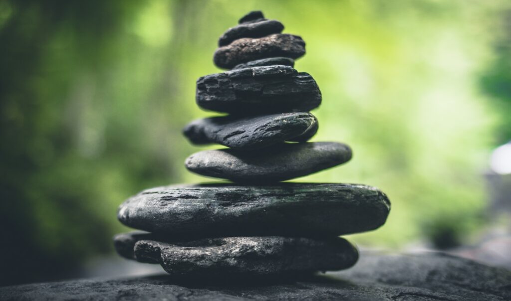 black stacking stones on gray surface