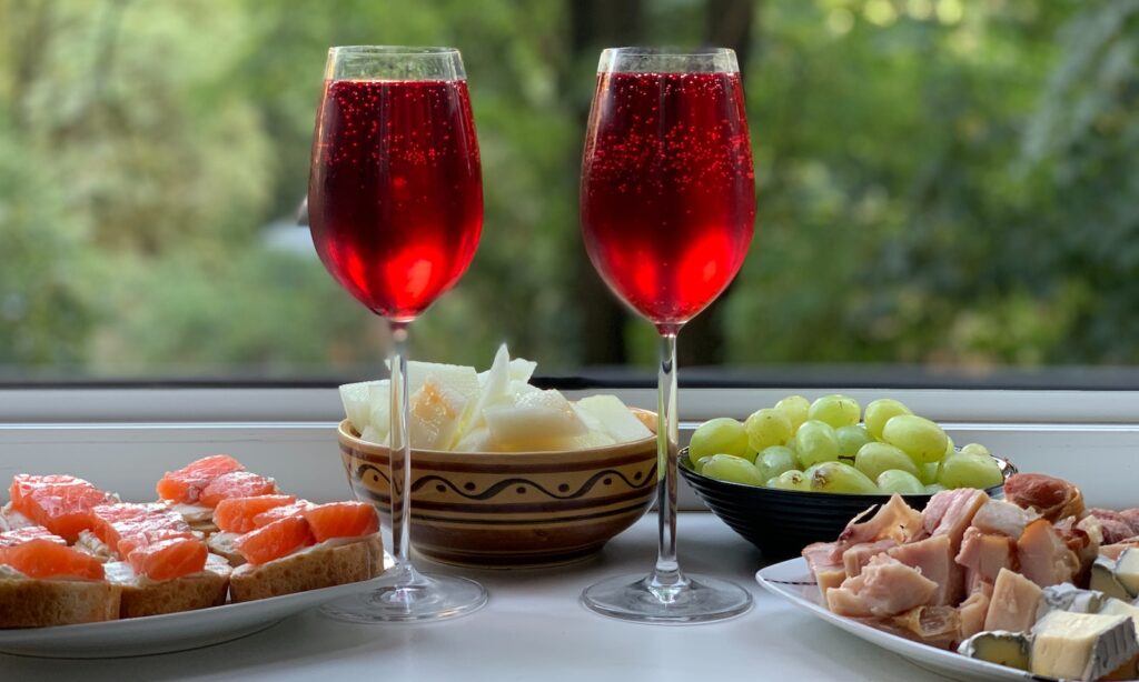 two wine glasses with red wine on table