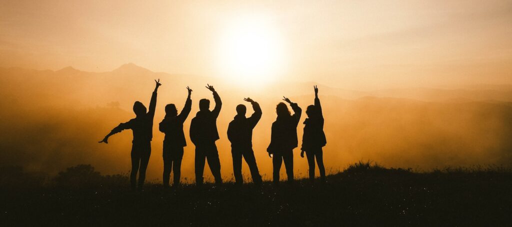 silhouette photo of six persons on top of mountain