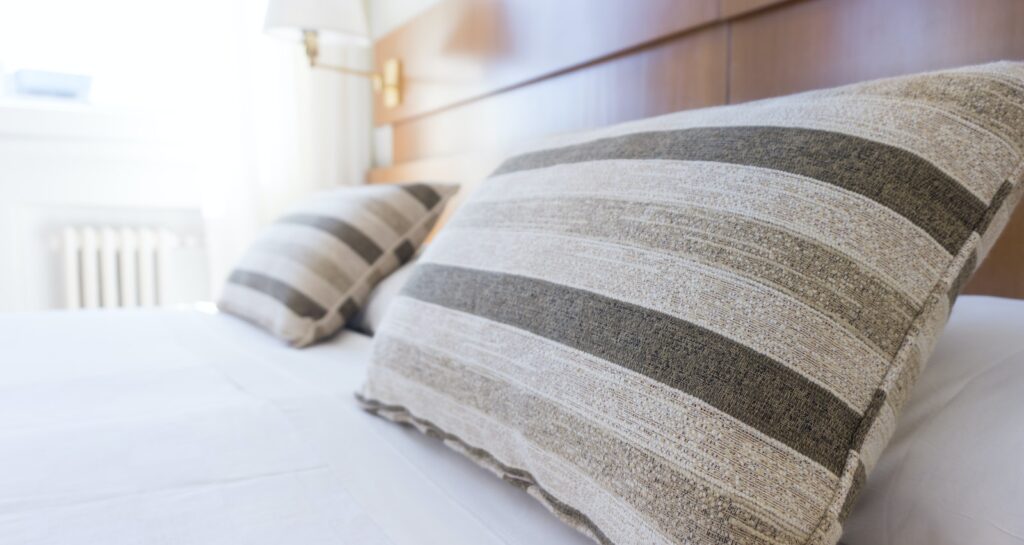 gray and black throw pillow on bed