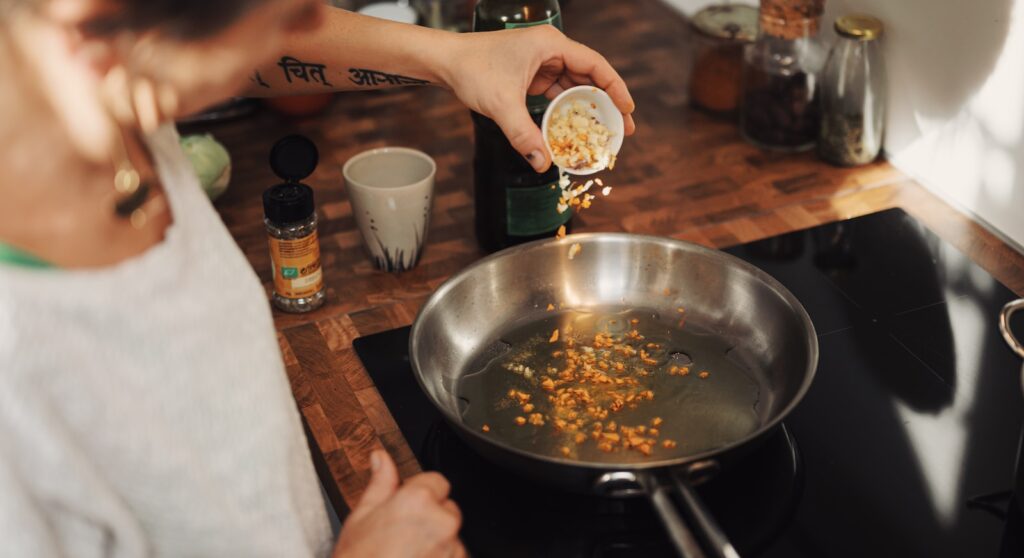 person holding stainless steel round tray with food