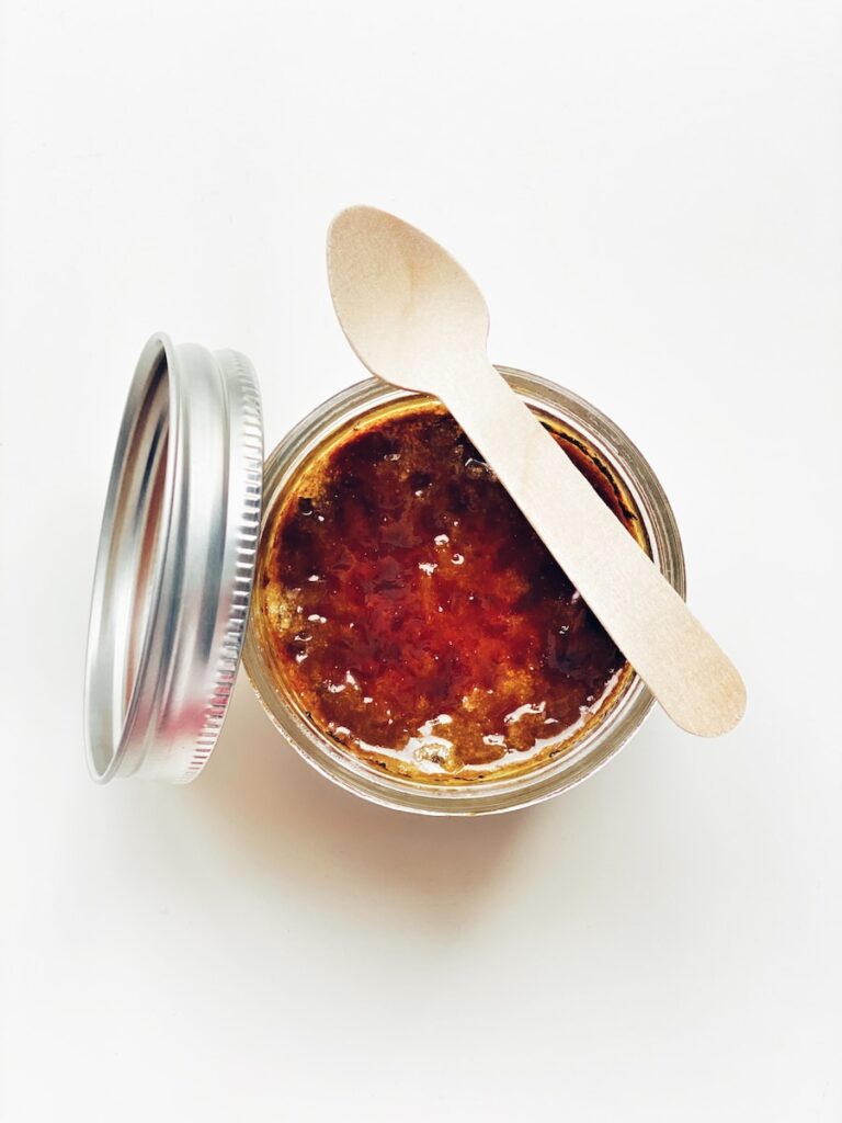 brown liquid in clear glass jar