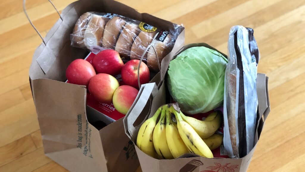 apples and bananas in brown cardboard box