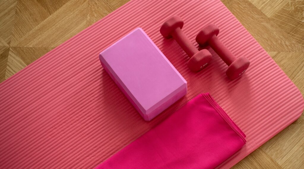 pink dumbbell on pink textile