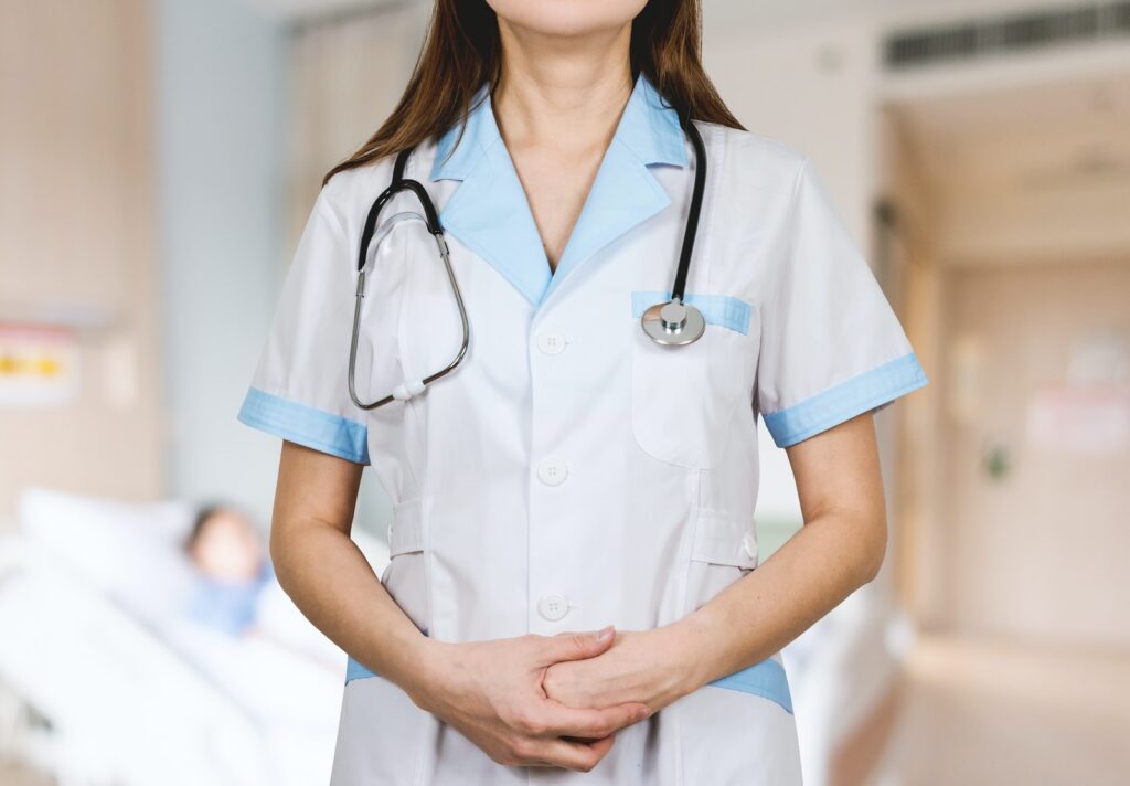 woman in white button up shirt and blue stethoscope