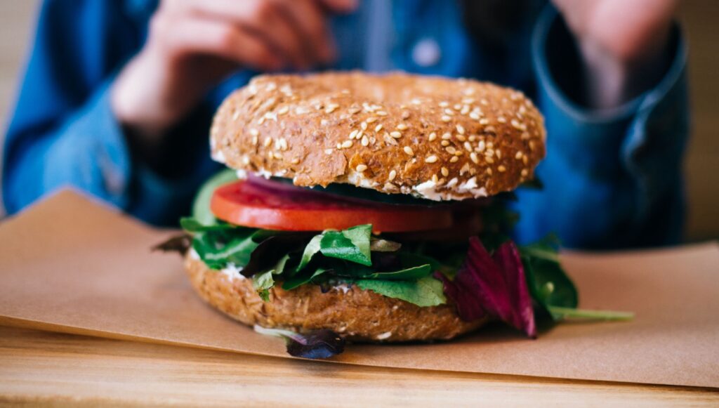 tilt photography of burger on brown pad