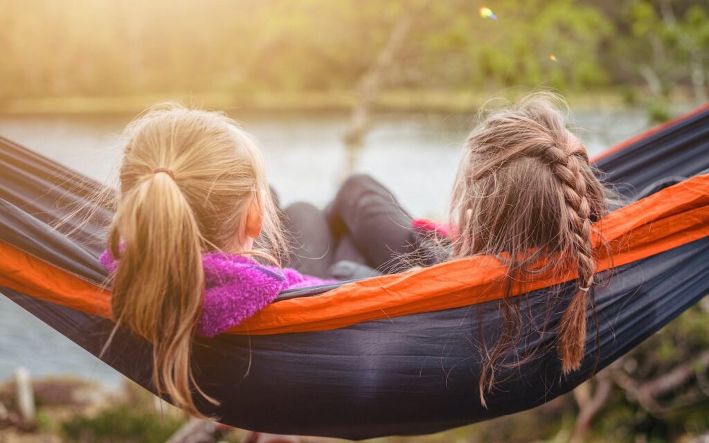 two women lying on hammock