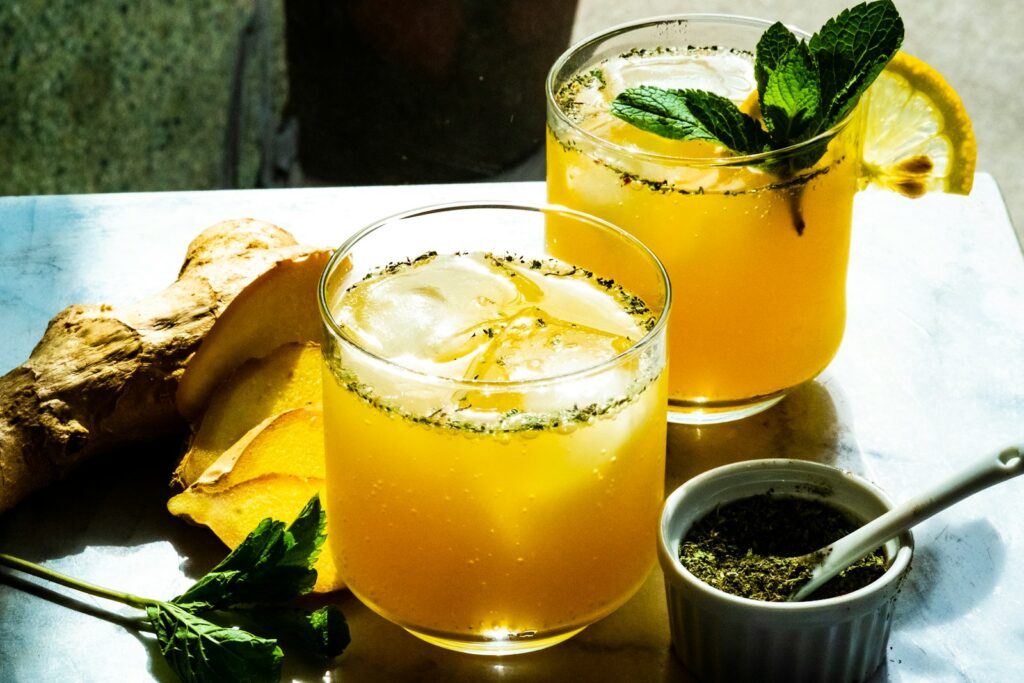 two clear glass cup with lemon juices