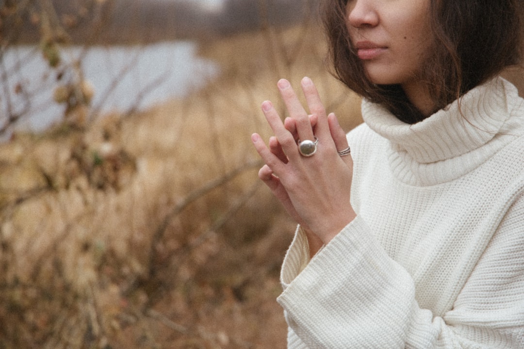 Woman wearing layered knits and turtlenecks in a city winter setting