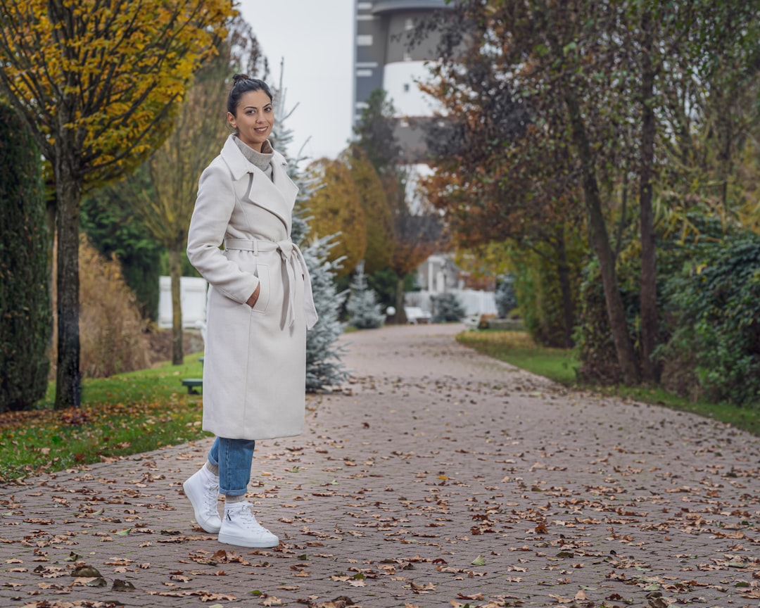 Alt text: Cream wool coat over neutral layered outfit for fall street style