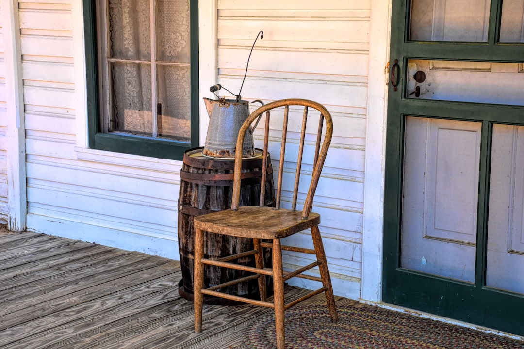 Alt text: dried branches in ceramic vase on porch step