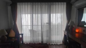 Alt text: cozy fall window layers with sheer curtains and velvet drapes