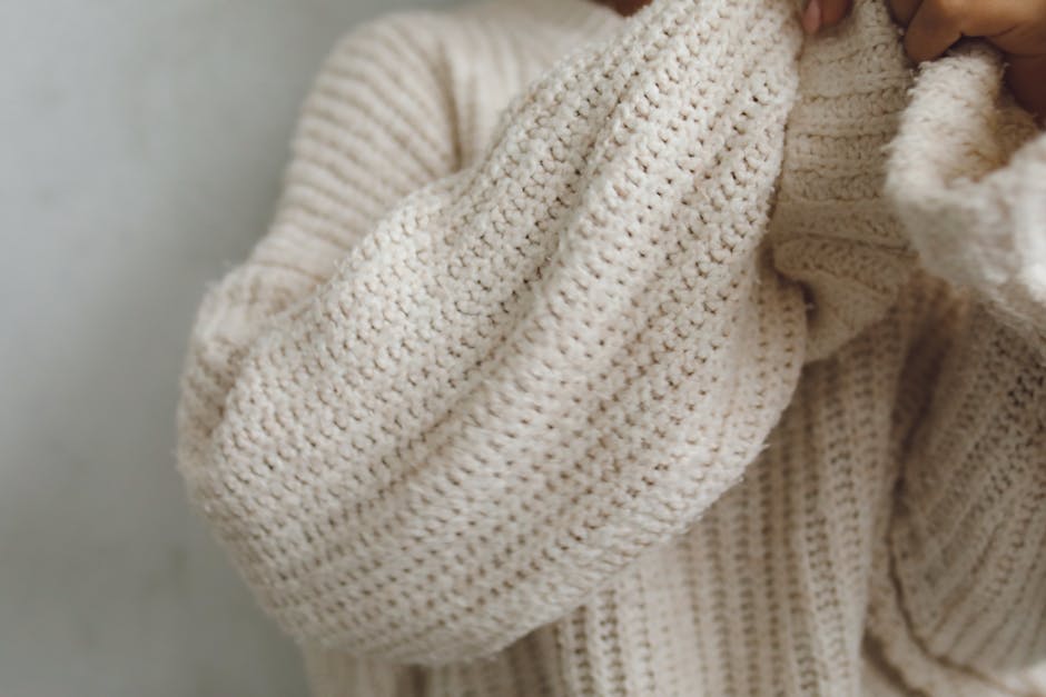 Close-up of layered knits and turtlenecks showing texture contrast