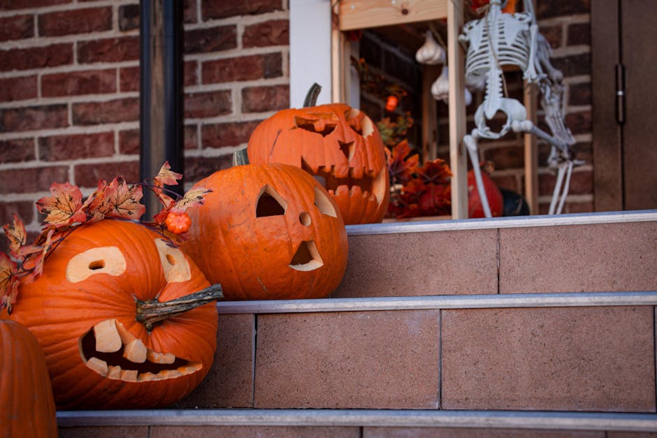 Alt text: pumpkins and lantern on porch step for cozy fall front porch