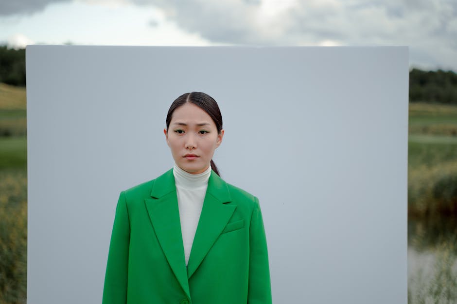 White turtleneck peeking out under a green slip dress as fall layering pieces