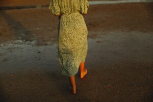 Chunky knits paired with a floral maxi dress and brown leather ankle boots for autumn style
